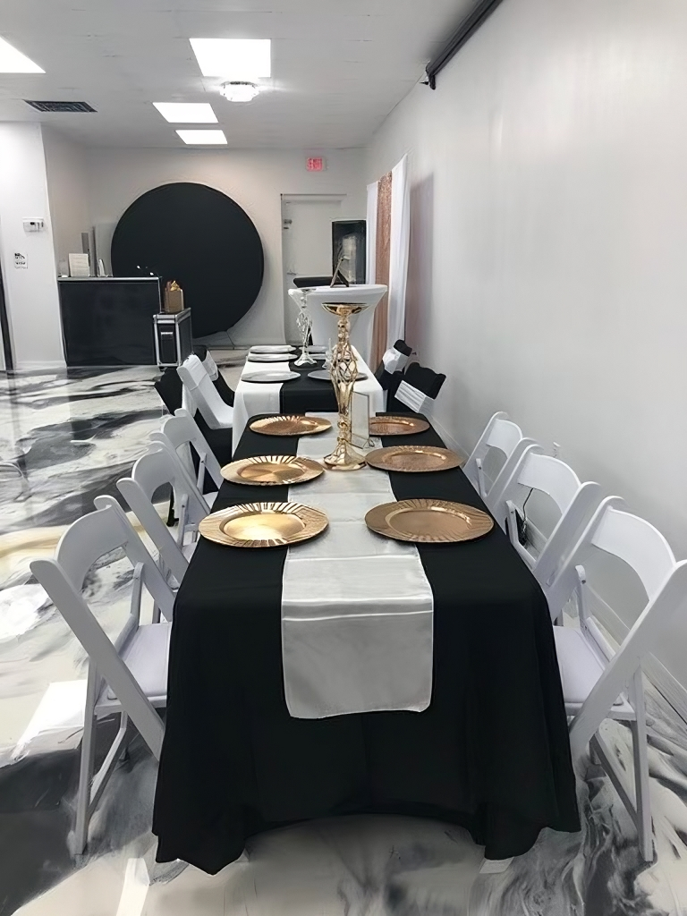 Event setup with round tables and projector at La Mercedes Events in Pasco, FL